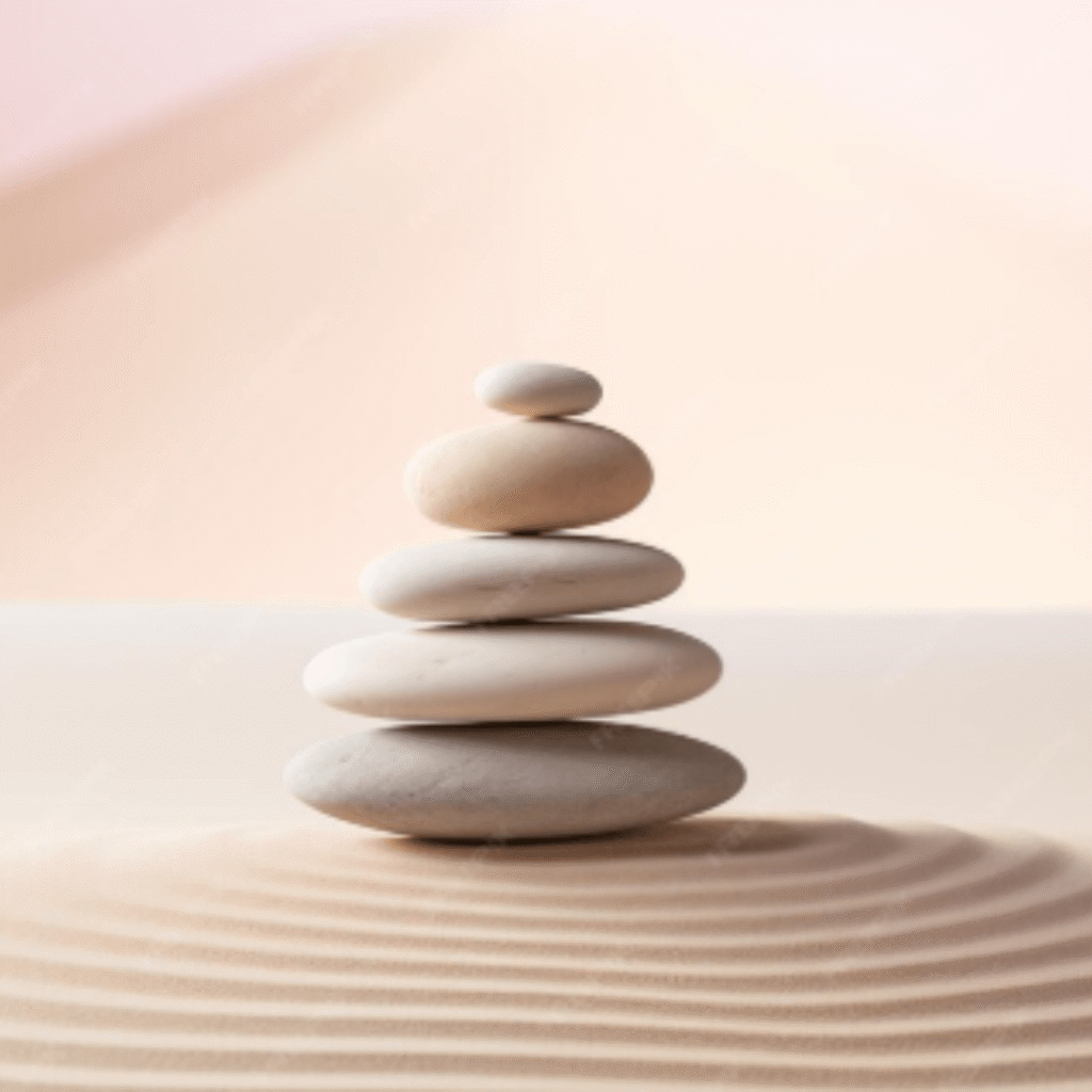 Zen stones stack on raked sand