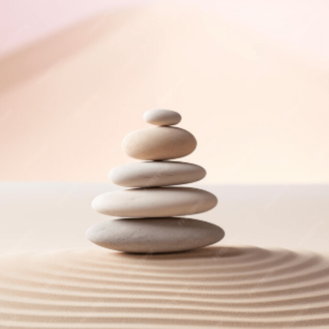 Zen stones stack on raked sand